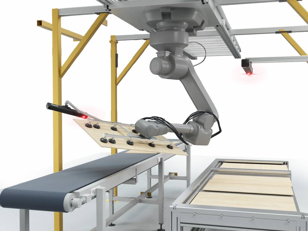 In einer Produktionseinrichtung in der Slowakei verpacken Vision-gesteuerte Roboter Möbelteile automatisiert in Kartons.