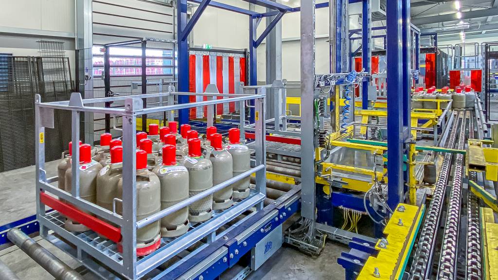 Platzsparendes Anlagenlayout von HaRo Anlagen- und Fördertechnik für den Kreislauf der Einschleusung, Entladung, Befüllung, Beladung und abschließender Ausschleusung von Gasflaschen bei Caratgas.